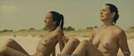 Veronica Sanchez and Marta Milans topless on a beach in El e